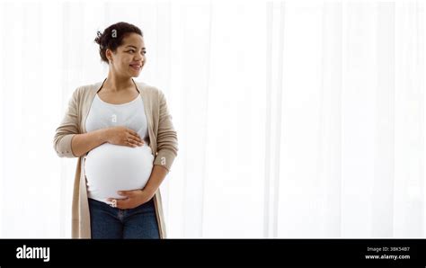 Mother embracing her pregnant belly