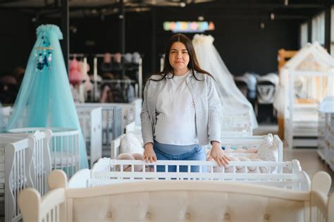 Parents choosing a crib in a store