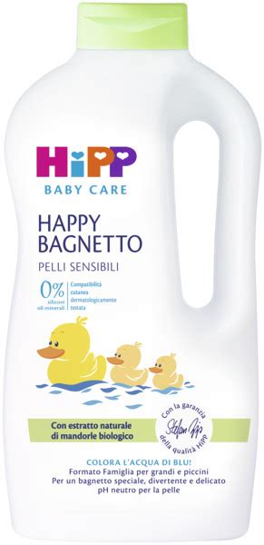 Dettaglio della confezione di HiPP Happy Bagnetto accanto a una boccetta con acqua colorata di verde, che evidenzia la sicurezza e la trasparenza del prodotto.