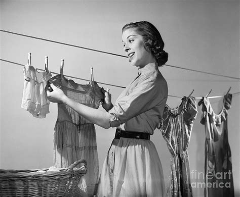 Woman hanging clothes to dry in the 70s
