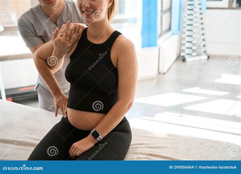 Donna incinta in piscina con istruttore