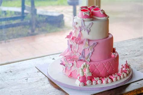 Esempio di torta a piani con decorazioni in pasta di zucchero a tema nascita