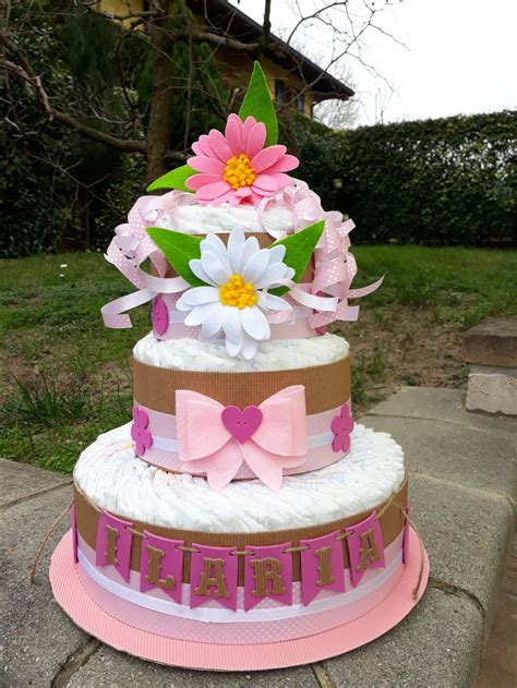 Torta di pannolini classica a tre livelli decorata con nastri e peluche