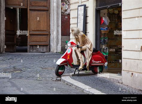 Bambino felice seduto su una Vespa PX con un seggiolino