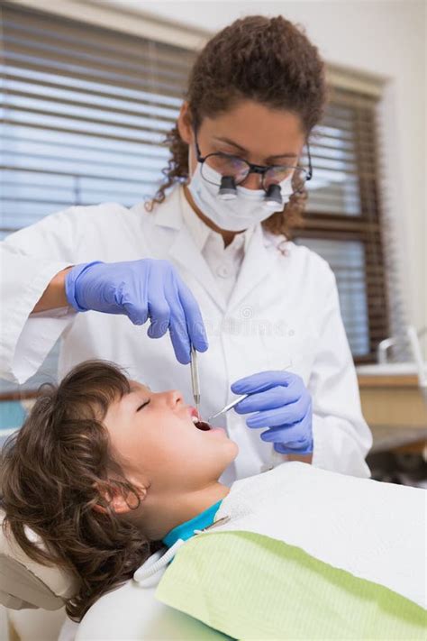 Dentista pediatrico che esamina un bambino in un ambiente amichevole