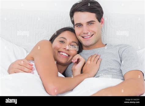 Coppia che si abbraccia romanticamente a letto
