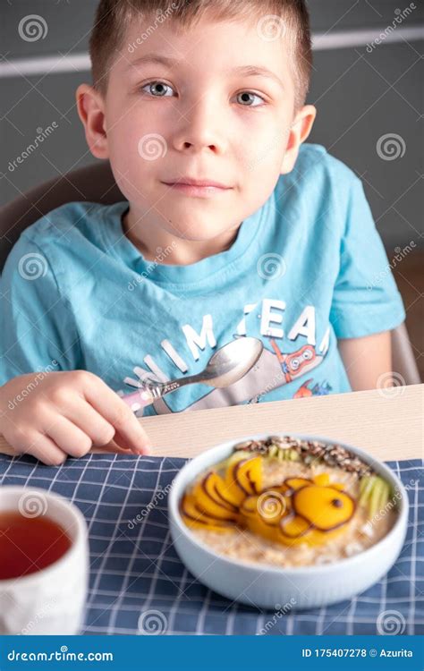 Bambino seduto al tavolo che mangia