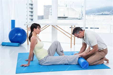Pregnant woman exercising with a physiotherapist