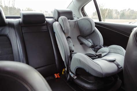 Car interior showing rear seats, possibly with child car seat