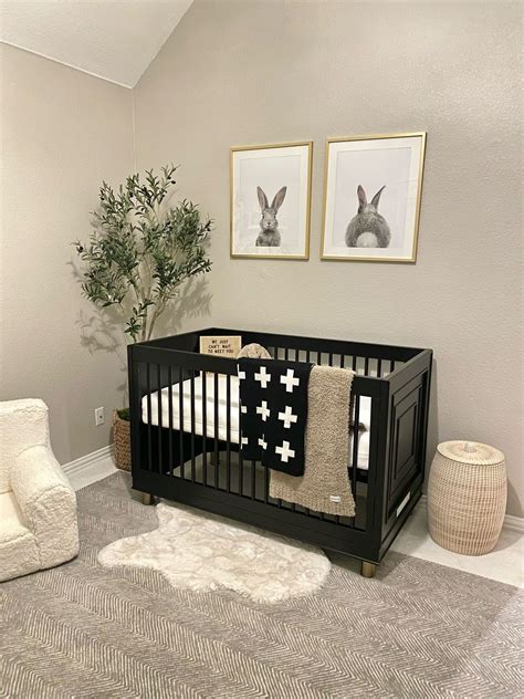 Nursery room with crib, dresser, and wardrobe