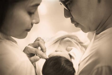 Genitori che tengono in braccio il loro neonato con un biberon in primo piano