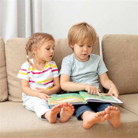 Bambini che giocano e leggono sul divanetto convertito dalla culla Allegra