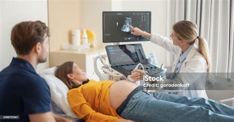 Doctor explaining ultrasound to pregnant couple