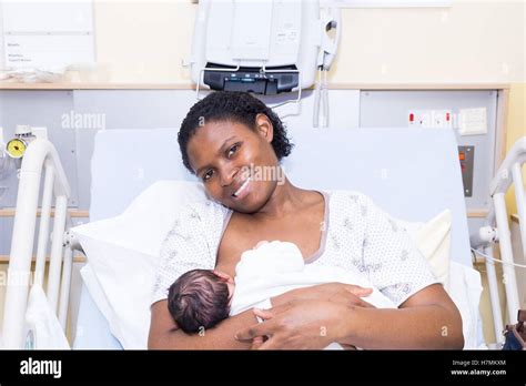 Mother breastfeeding baby in hospital