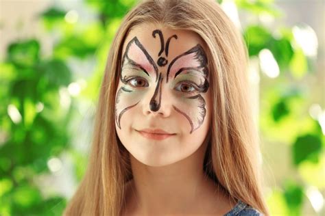 Bambino con il trucco da clown triste, con lacrima blu sotto l'occhio e sopracciglia all'ingiù