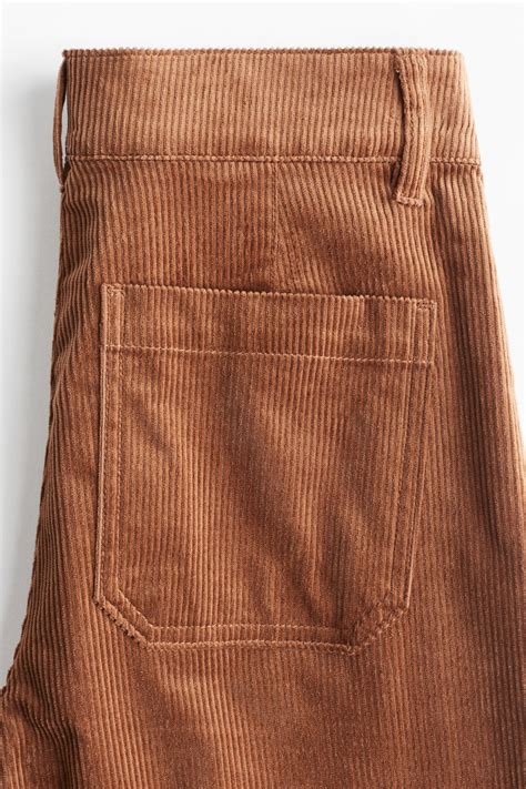 Bambina che indossa pantaloni in velluto a costine in un ambiente giocoso
