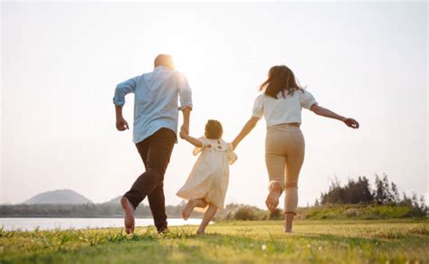 Famiglia che corre in un prato verde di agriturismo