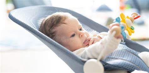 Child playing in a bouncer