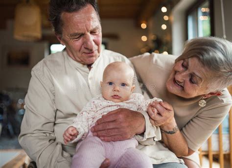 Grandparents holding personalized baby item