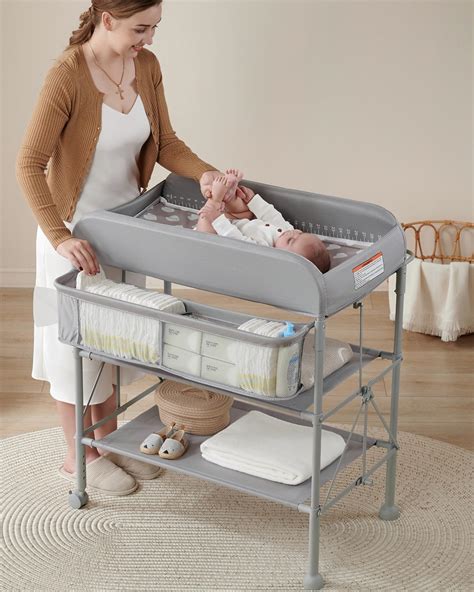 A parent giving a bath to a baby in a Foppapedretti changing table with an integrated tub