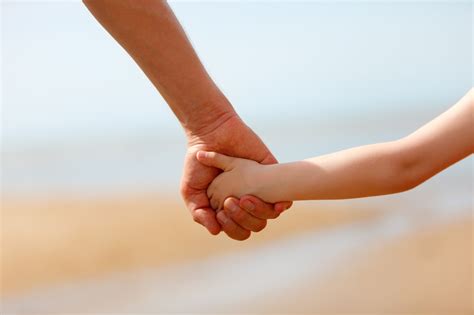 Child and parent holding hands, illustrating boundaries