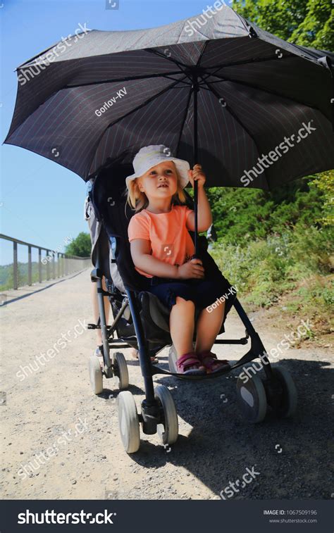 Child protected from rain in a stroller