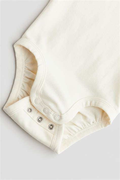Dettaglio tessuto body in cotone