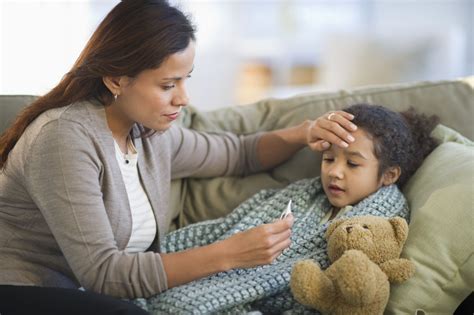 Parents taking child's temperature