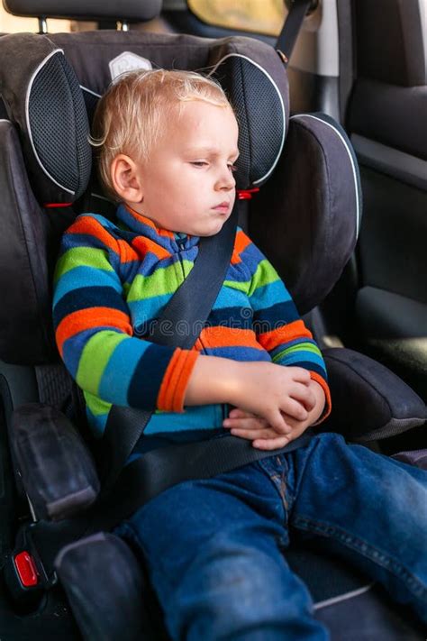 Bambino seduto in un seggiolino auto pulito