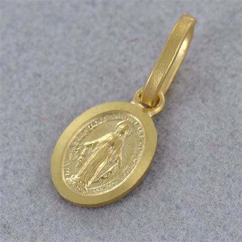 Dettaglio di un'incisione personalizzata su una medaglia in oro giallo, simbolo di un ricordo eterno