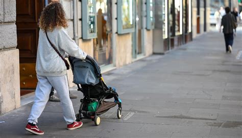foto ambientata di un genitore che utilizza il passeggino Compact con una borsa coordinata in un ambiente cittadino