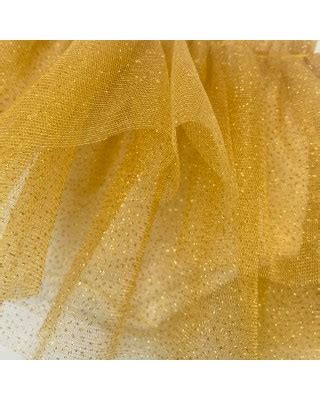 Dettaglio ravvicinato del fiocco in vita e della texture del tulle glitterato
