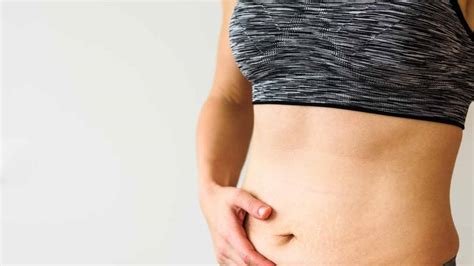 Donna in gravidanza con le mani sulla pancia che si massaggia le gambe