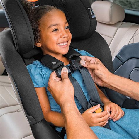 Child car seat harness adjustment showing importance of snug fit
