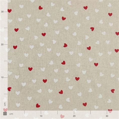 Tessuto di cotone avorio con piccoli cuori disegnati