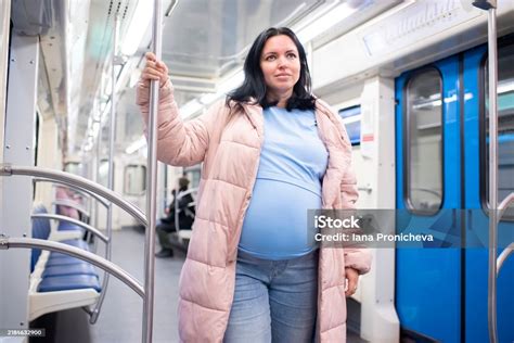 Pregnant woman in public transport seat