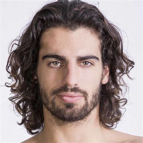 Uomo con viso quadrato e capelli lunghi mossi
