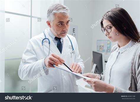 Doctor explaining complex medical results to a patient couple