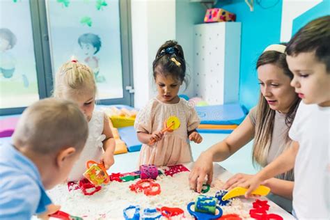 Children engaged in a sensory play activity in a nursery