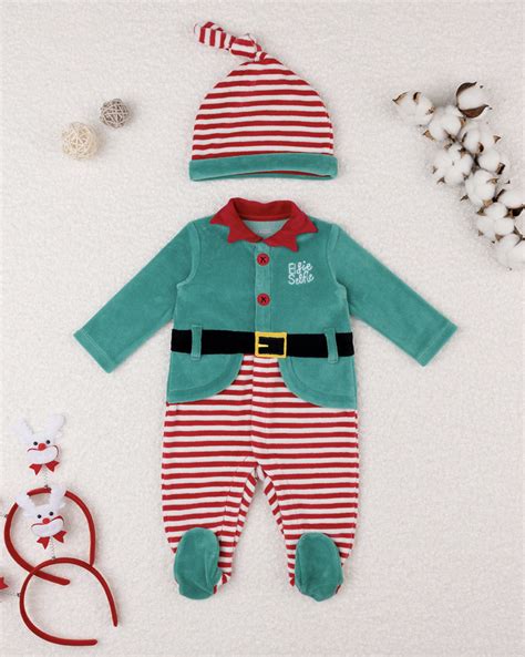 Bambina con tutina a elfo durante il primo Natale
