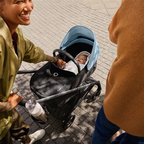Bambino in passeggino osservato da un adulto