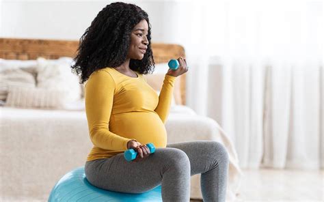 Pregnant woman exercising with a professional trainer