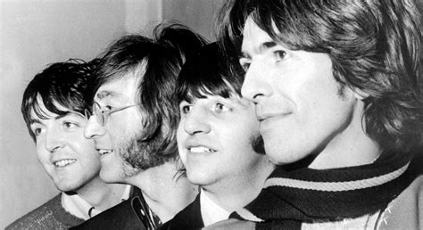 I quattro Beatles durante un concerto negli anni '60