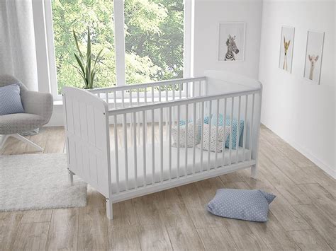 bambino che dorme in un lettino con una barriera di sicurezza