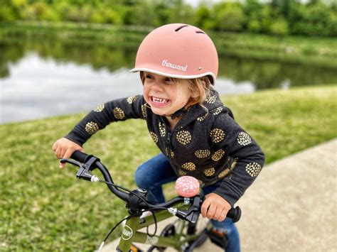 Child wearing a helmet in a bike seat