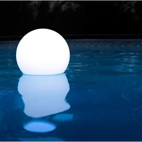 Sfera luminosa di 60 cm posizionata a bordo piscina in un giardino notturno