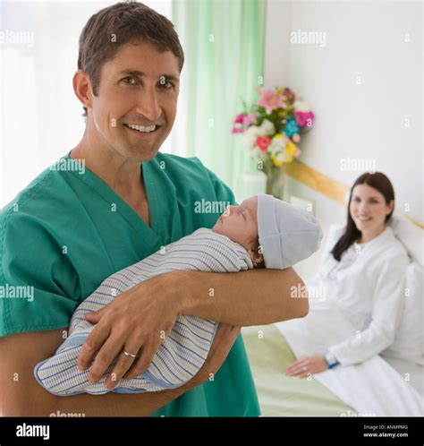 Father holding newborn in hospital