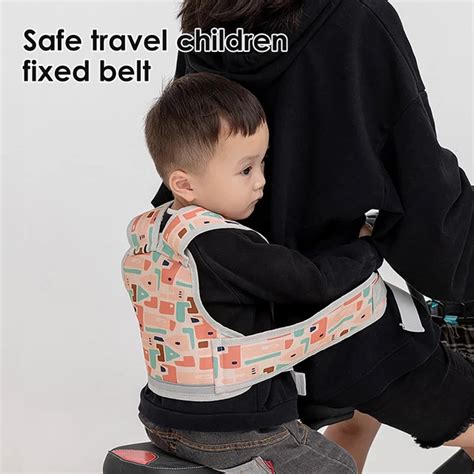 Child in a bike seat with safety harness