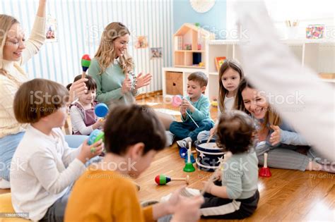 Music teacher interacting with children