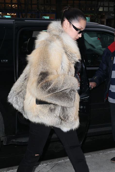 Bella Hadid wearing fur coat and hoodie
